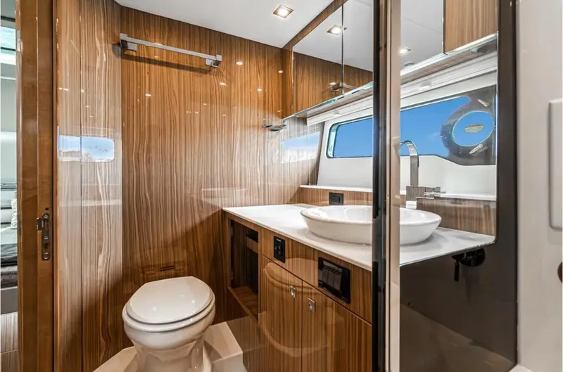 Slide: The Image of Luxurious bathroom in 2025 Cruisers Yachts 50 GLS with modern fixtures and wood paneling. - 40