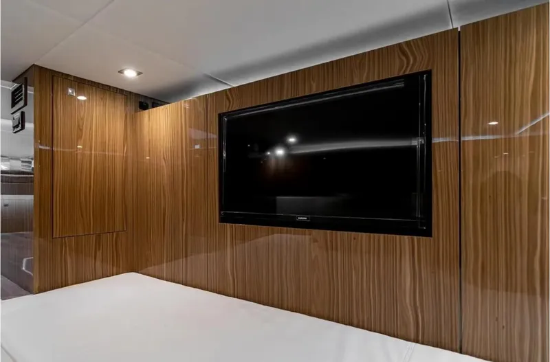 Slide: The Image of Interior of 2025 Cruisers Yachts 50 GLS with wood paneling and mounted TV. - 45