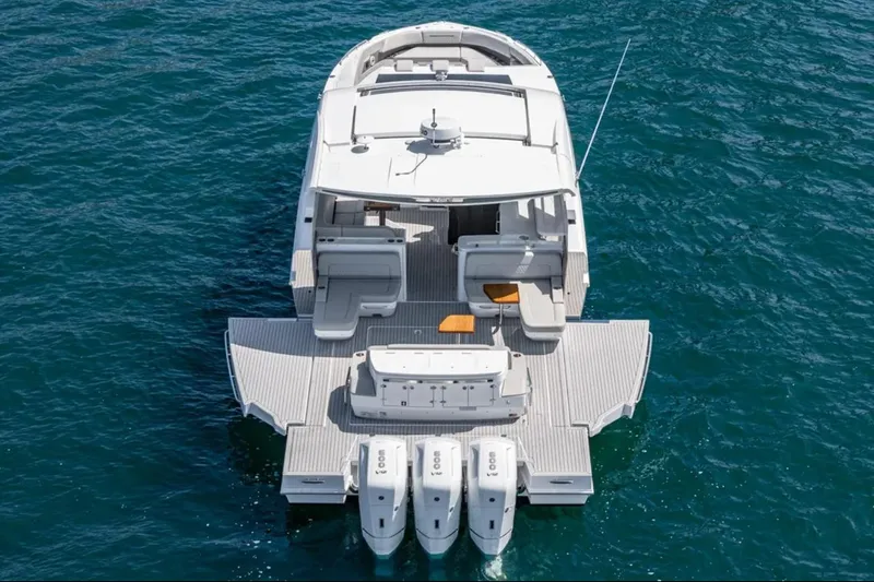 Slide: The Image of 2025 Cruisers Yachts 50 GLS on water, rear view with triple engines. - 6