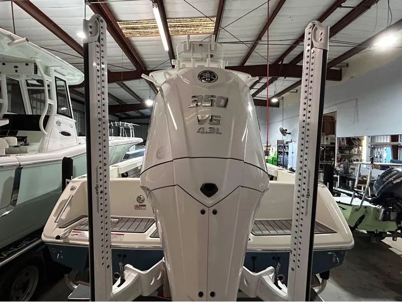 Slide: The Image of 2025 Pathfinder 2400 TRS boat with powerful 350 V8 engine in a showroom. - 2