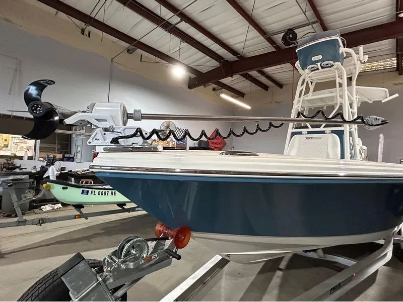 Slide: The Image of 2025 Pathfinder 2400 TRS boat in a garage, featuring a trolling motor. - 6