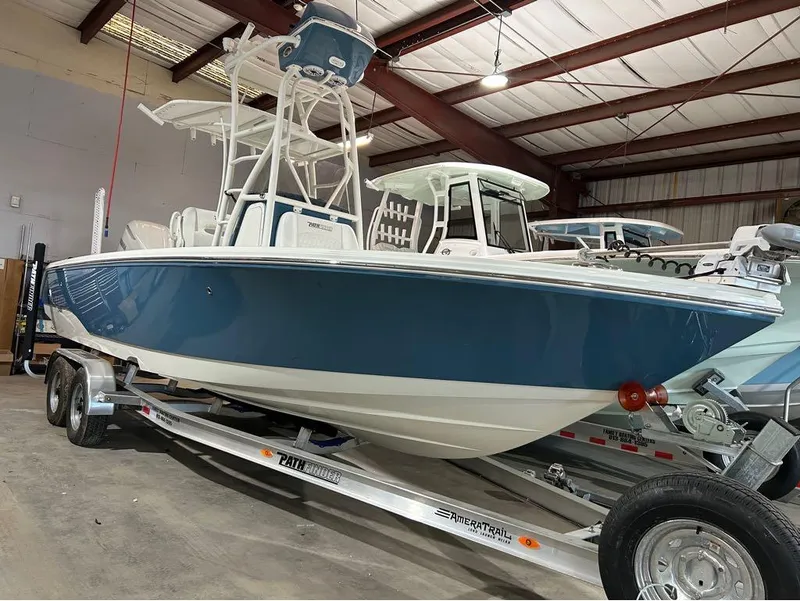 Slide: The Image of 2025 Pathfinder 2400 TRS boat on trailer in indoor storage facility. - 7