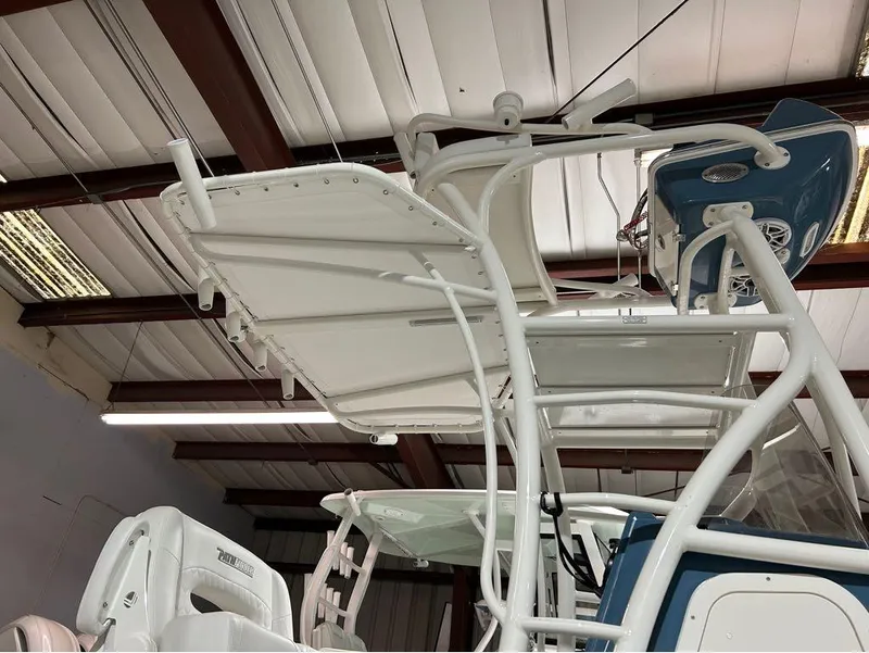 Slide: The Image of 2025 Pathfinder 2400 TRS boat interior with white seating and overhead structure. - 8