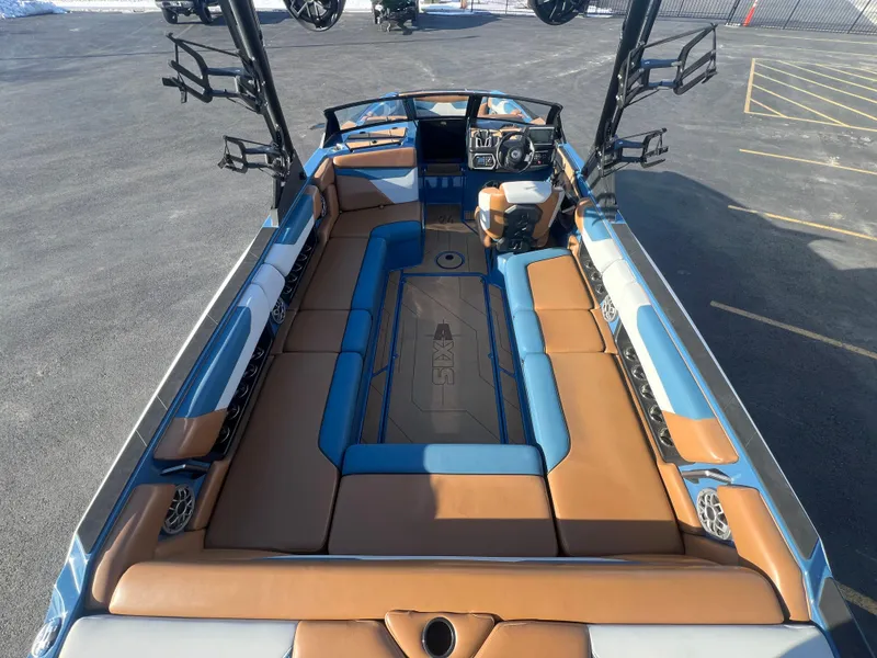 Slide: The Image of 2022 Axis Wake Research A24 boat interior with tan and blue seating. - 11