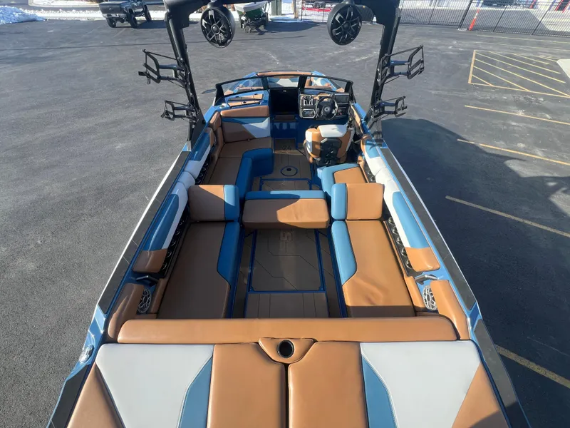Slide: The Image of 2022 Axis Wake Research A24 boat interior with tan and blue seating. - 12