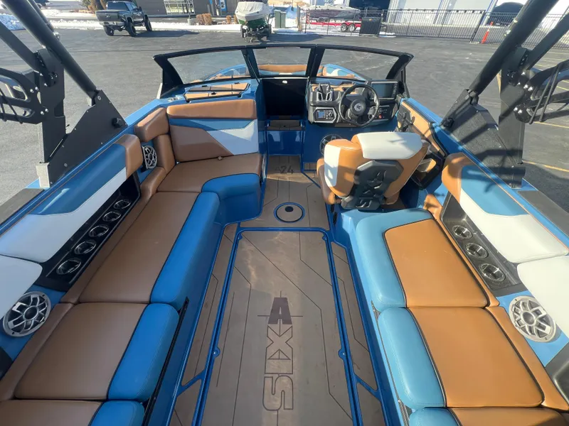 Slide: The Image of 2022 Axis Wake Research A24 boat interior with blue and brown seating. - 13