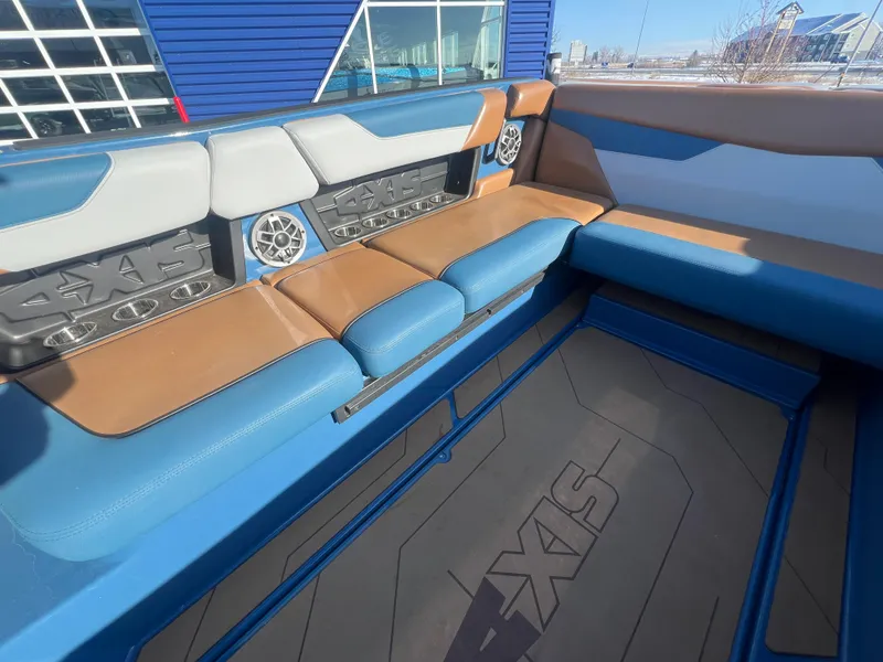 Slide: The Image of 2022 Axis Wake Research A24 boat interior with blue and brown seating. - 14