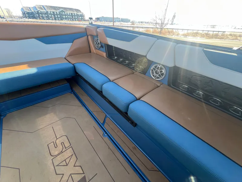 Slide: The Image of 2022 Axis Wake Research A24 boat interior with blue and tan seating. - 15