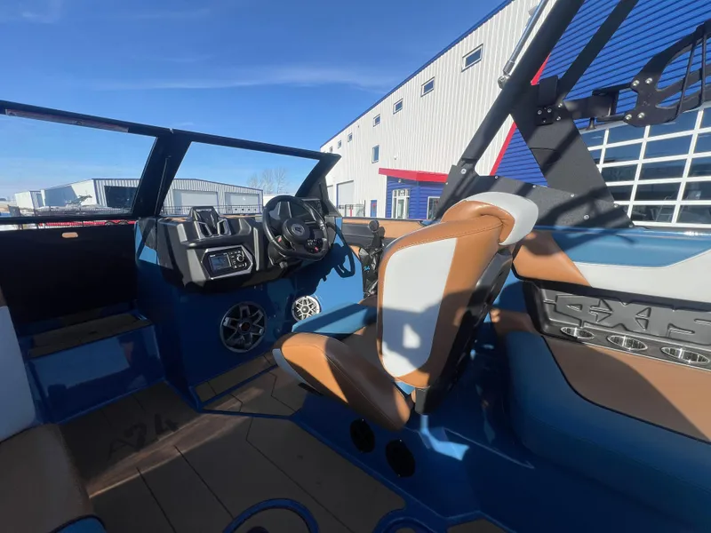 Slide: The Image of 2022 Axis Wake Research A24 boat interior with modern dashboard and seating. - 16