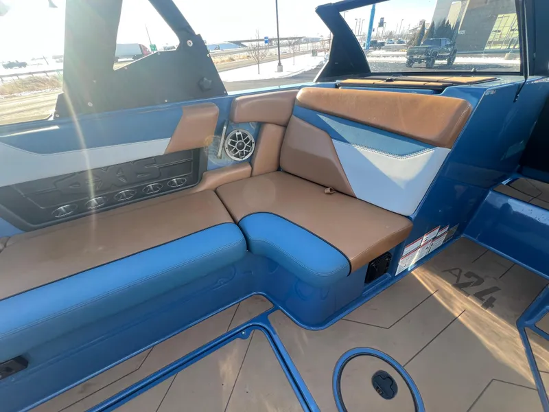 Slide: The Image of 2022 Axis Wake Research A24 boat interior with blue and tan seating. - 18