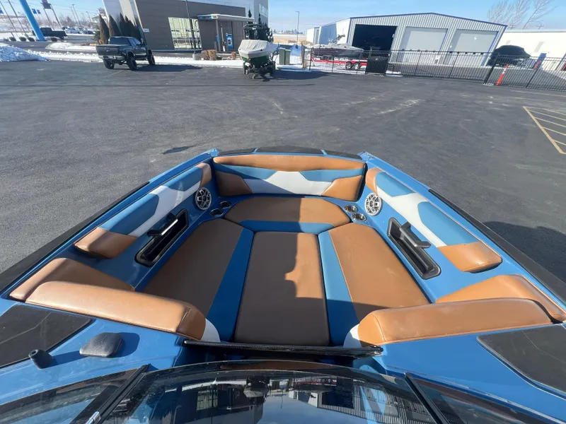 Slide: The Image of 2022 Axis Wake Research A24 boat interior with blue and brown seating. - 19