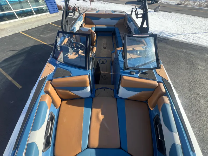 Slide: The Image of 2022 Axis Wake Research A24 boat interior with blue and tan seating. - 21