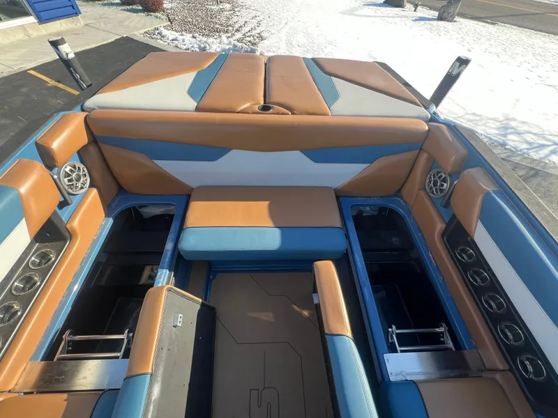 Slide: The Image of 2022 Axis Wake Research A24 boat interior with blue and tan seating and storage compartments. - 22