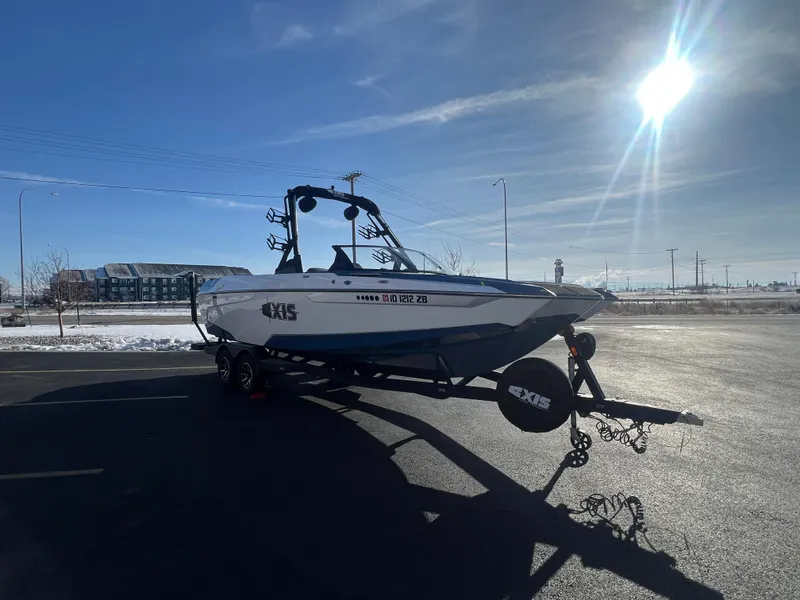 Slide: The Image of 2022 Axis Wake Research A24 boat on trailer under bright sun. - 7