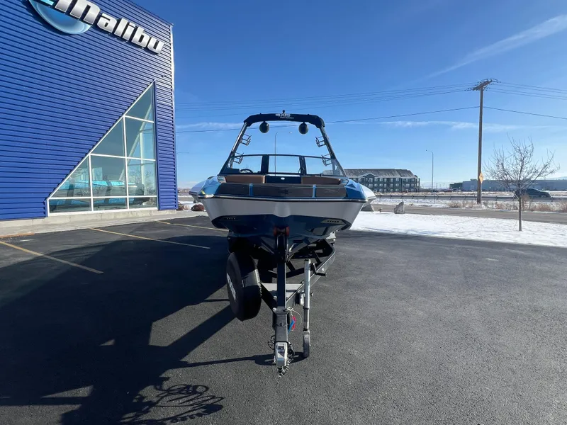 Slide: The Image of 2022 Axis Wake Research A24 boat on trailer outside Malibu dealership. - 8