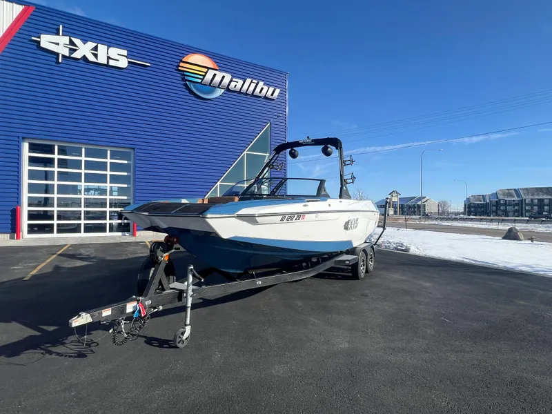 Slide: The Image of 2022 Axis Wake Research A24 boat on trailer outside dealership. - 9