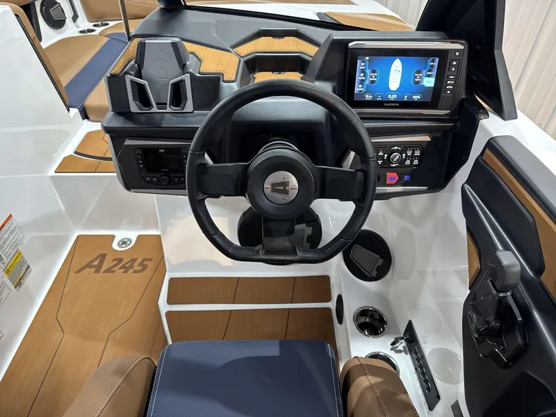 Slide: The Image of 2025 Axis A245 boat dashboard with steering wheel and digital display. - 11