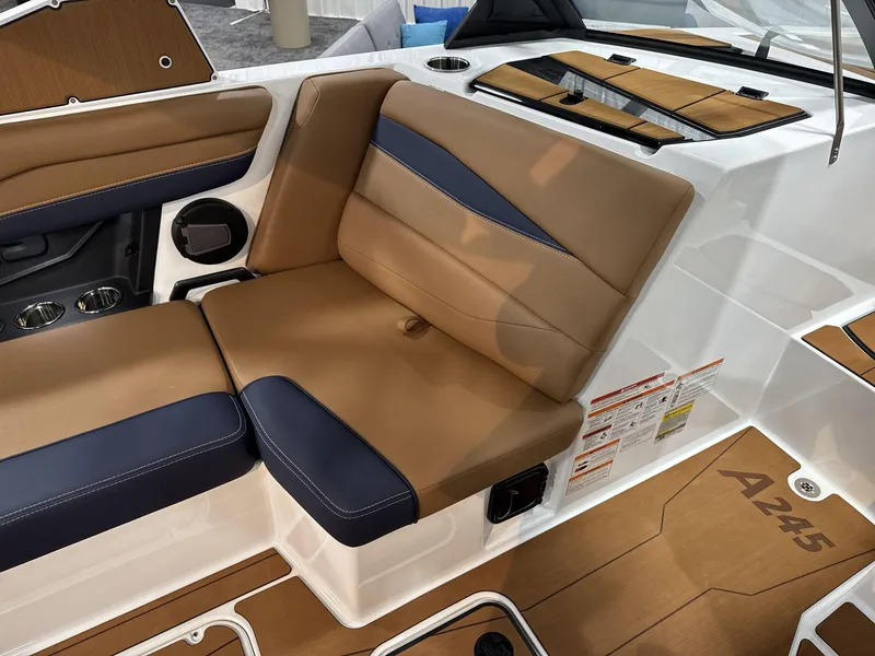 Slide: The Image of 2025 Axis A245 boat interior with tan and navy seating, modern design. - 12