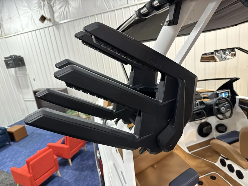 Slide: The Image of 2025 Axis A245 boat interior with black wakeboard rack and modern dashboard. - 14