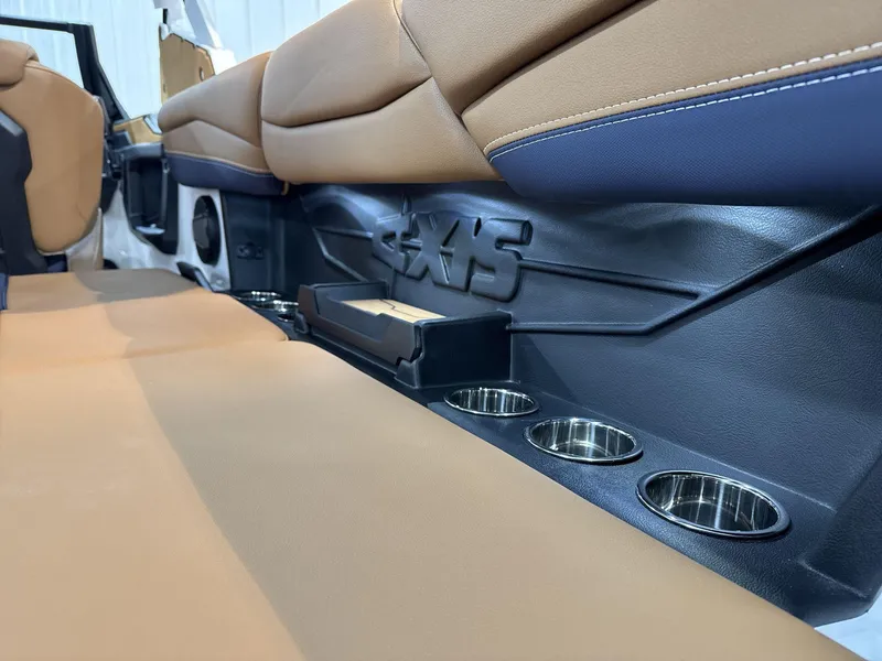 Slide: The Image of 2025 Axis A245 interior with tan seats and built-in cup holders. - 15