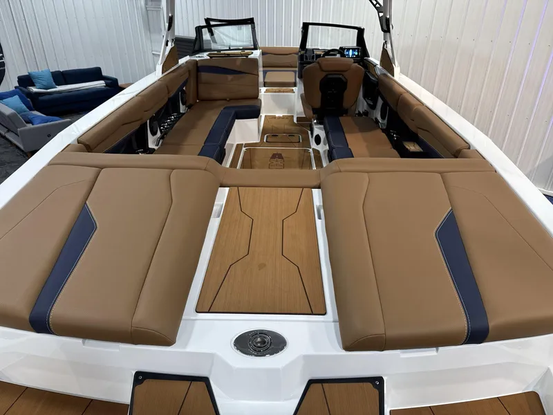 Slide: The Image of 2025 Axis A245 boat interior with tan and navy seating, spacious layout. - 17