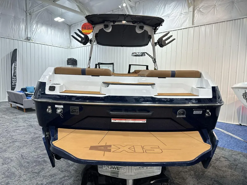 Slide: The Image of 2025 Axis A245 boat on display in showroom, rear view. - 4