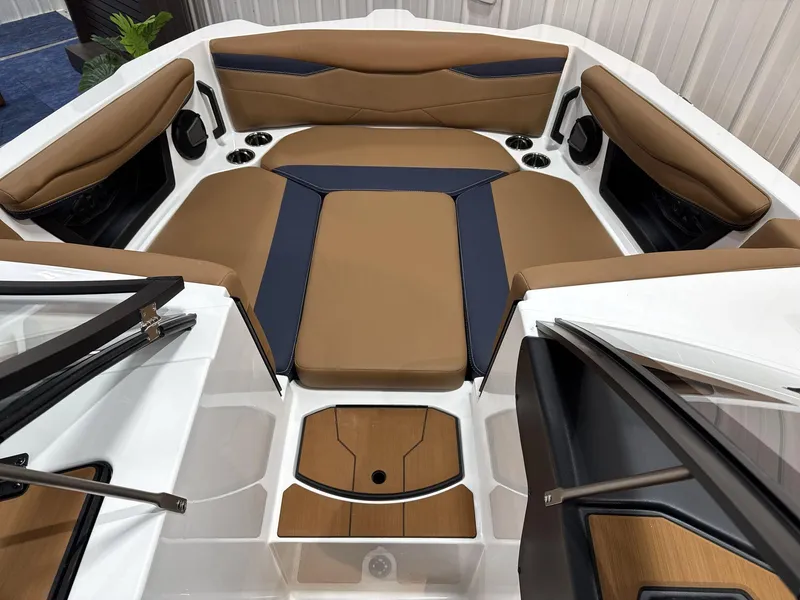 Slide: The Image of 2025 Axis A245 boat interior with tan and navy seating, cup holders, and sleek design. - 7