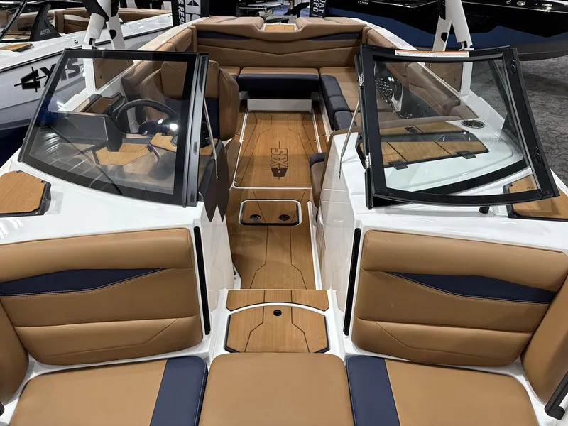 Slide: The Image of 2025 Axis A245 boat interior with tan and navy seating, sleek dashboard, and modern design. - 8