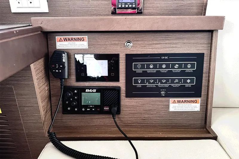 Slide: The Image of Control panel of a 2019 Lagoon 40 catamaran with navigation and communication equipment. - 12