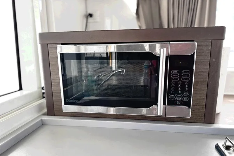 Slide: The Image of Microwave oven inside a 2019 Lagoon 40 catamaran kitchen area. - 14