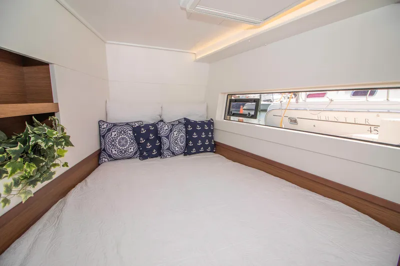 Slide: The Image of Cozy bedroom in 2019 Lagoon 40 catamaran with nautical-themed pillows and window view. - 26