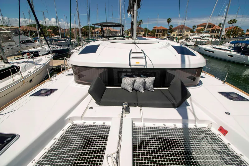 Slide: The Image of 2019 Lagoon 40 catamaran docked in marina, featuring spacious deck and seating area. - 4