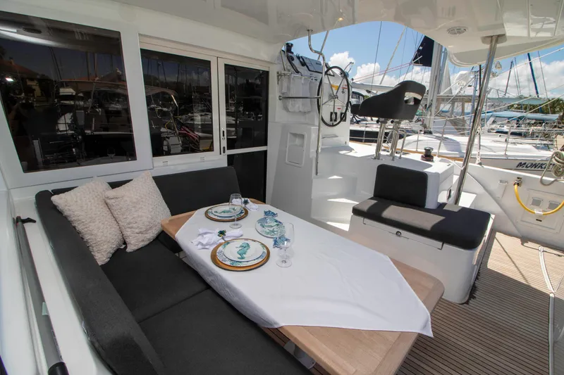 Slide: The Image of Luxurious Lagoon 40 catamaran cockpit with elegant dining setup, 2019 model. - 5