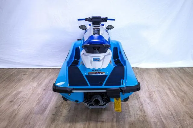 Slide: The Image of 2024 Yamaha Waverunner EX® Sport, blue and white, rear view on wooden floor. - 12
