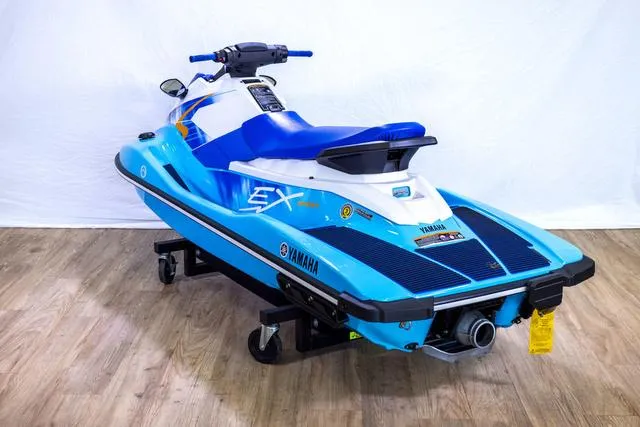 Slide: The Image of 2024 Yamaha Waverunner EX Sport in blue on display indoors. - 13