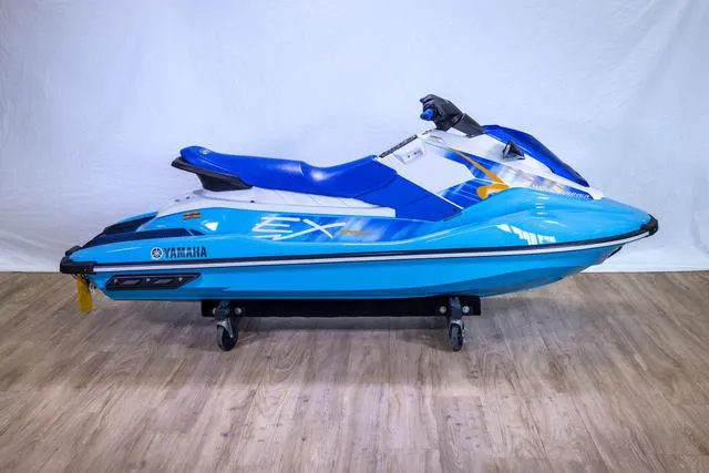Slide: The Image of 2024 Yamaha Waverunner EX® Sport in blue and white on display indoors. - 5