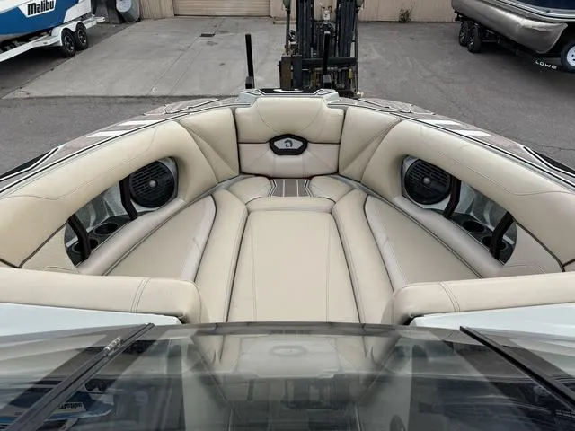 Slide: The Image of 2022 Centurion Ri245 boat interior with beige seating and built-in speakers. - 10