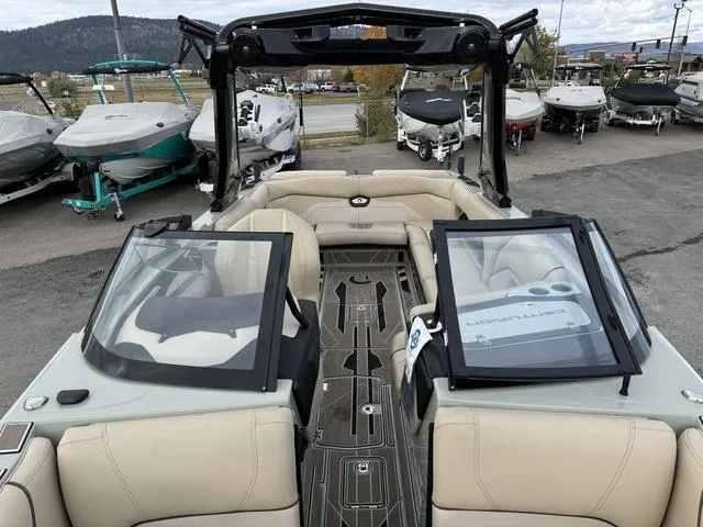 Slide: The Image of 2022 Centurion Ri245 boat interior with beige seating and open windshield. - 11