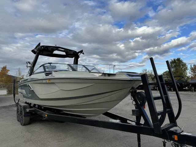 Slide: The Image of 2022 Centurion Ri245 boat on trailer under cloudy sky. - 3