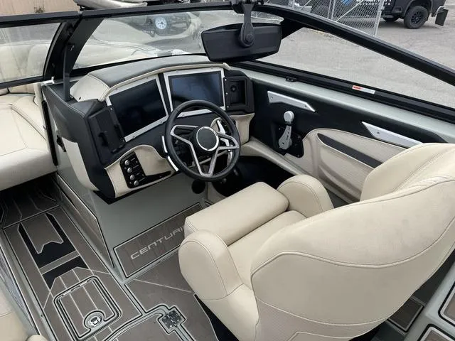 Slide: The Image of 2022 Centurion Ri245 boat interior with modern dashboard and steering wheel. - 9