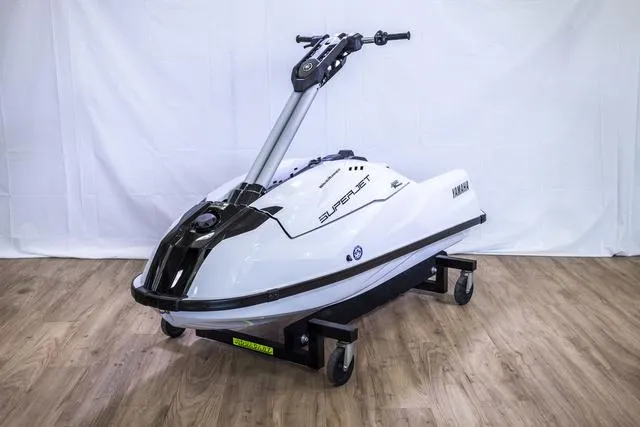 Slide: The Image of 2023 Yamaha Waverunner Superjet on display, sleek design, white body, wooden floor background. - 3
