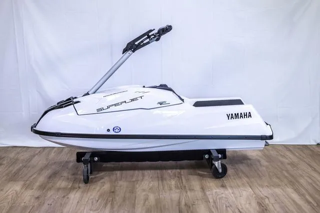 Slide: The Image of 2023 Yamaha Waverunner Superjet® on display, sleek white design, side view. - 6