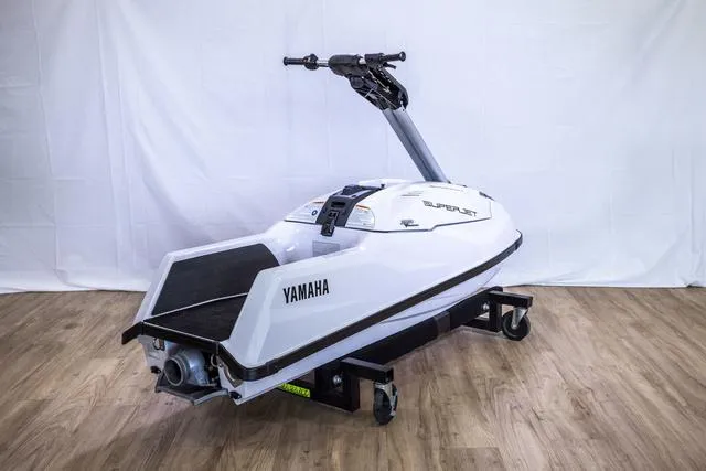 Slide: The Image of 2023 Yamaha Waverunner Superjet® on display, white with black accents, on a wooden floor. - 8