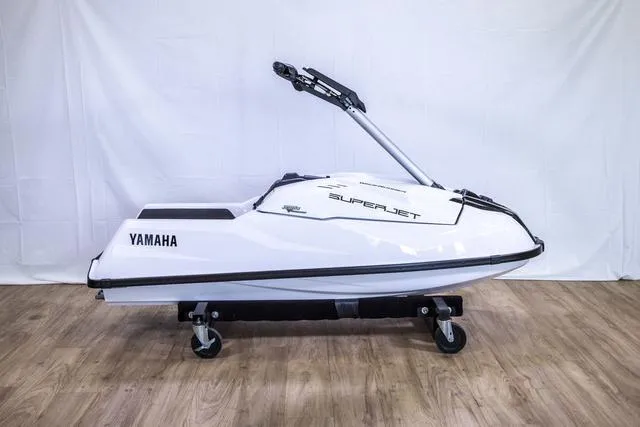 Slide: The Image of 2023 Yamaha Waverunner Superjet on display, white body, sleek design, wooden floor background. - 9