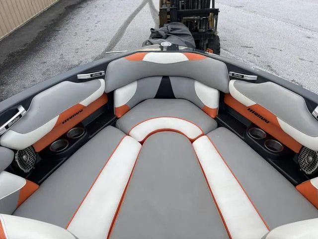 Slide: The Image of 2016 Malibu 22 VLX boat interior with gray, white, and orange seating. - 11