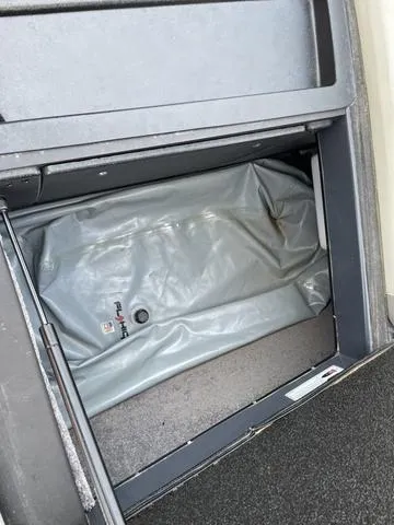 Slide: The Image of Storage compartment in a 2016 Malibu 22 VLX boat with a gray cover. - 19