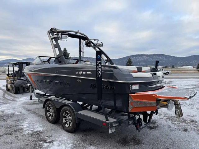 Slide: The Image of 2016 Malibu 22 VLX boat on trailer, snowy landscape background. - 3