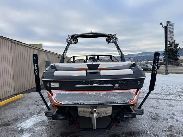 Slide: The Image of 2016 Malibu 22 VLX boat, rear view, parked on snowy pavement. - 4