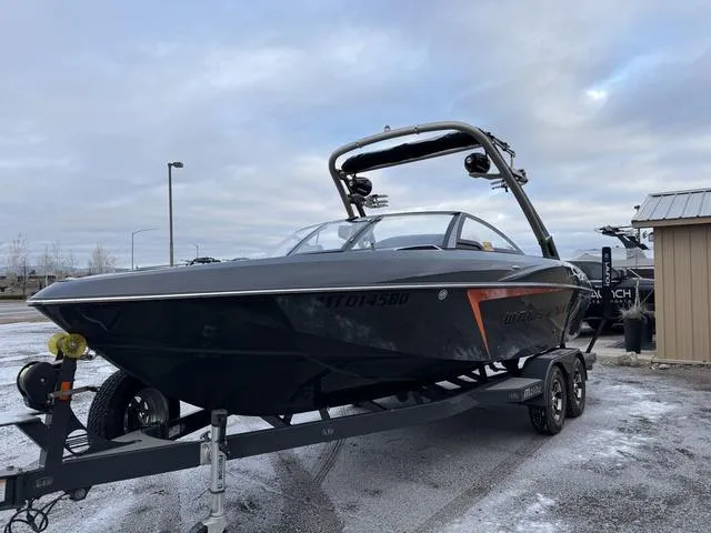 Slide: The Image of 2016 Malibu 22 VLX boat on trailer, parked outdoors on a cloudy day. - 5