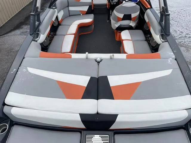 Slide: The Image of 2016 Malibu 22 VLX boat interior with orange, gray, and white seating. - 7